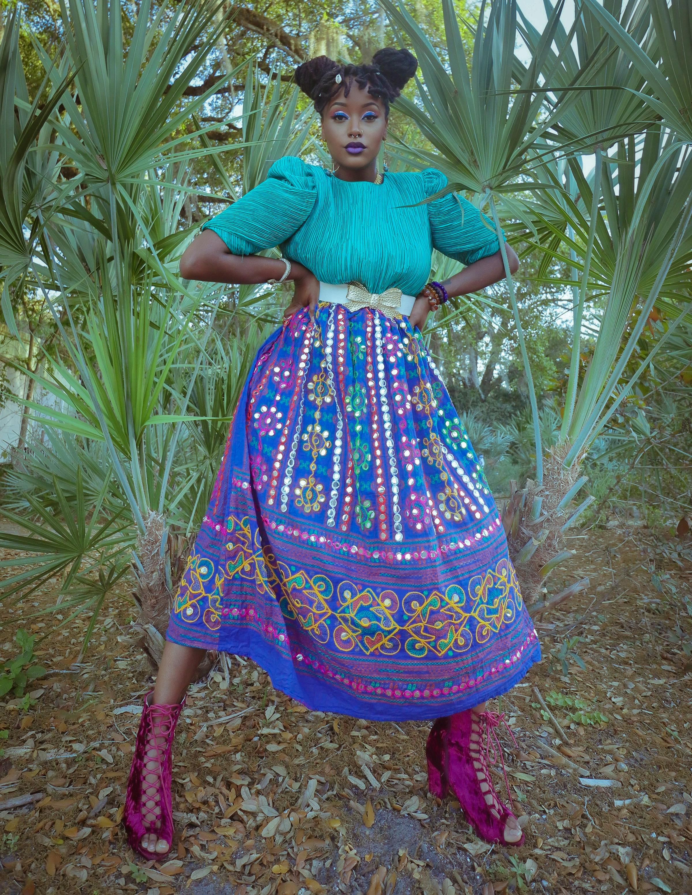 Woman in a colourful patterned dress with tropical palm trees