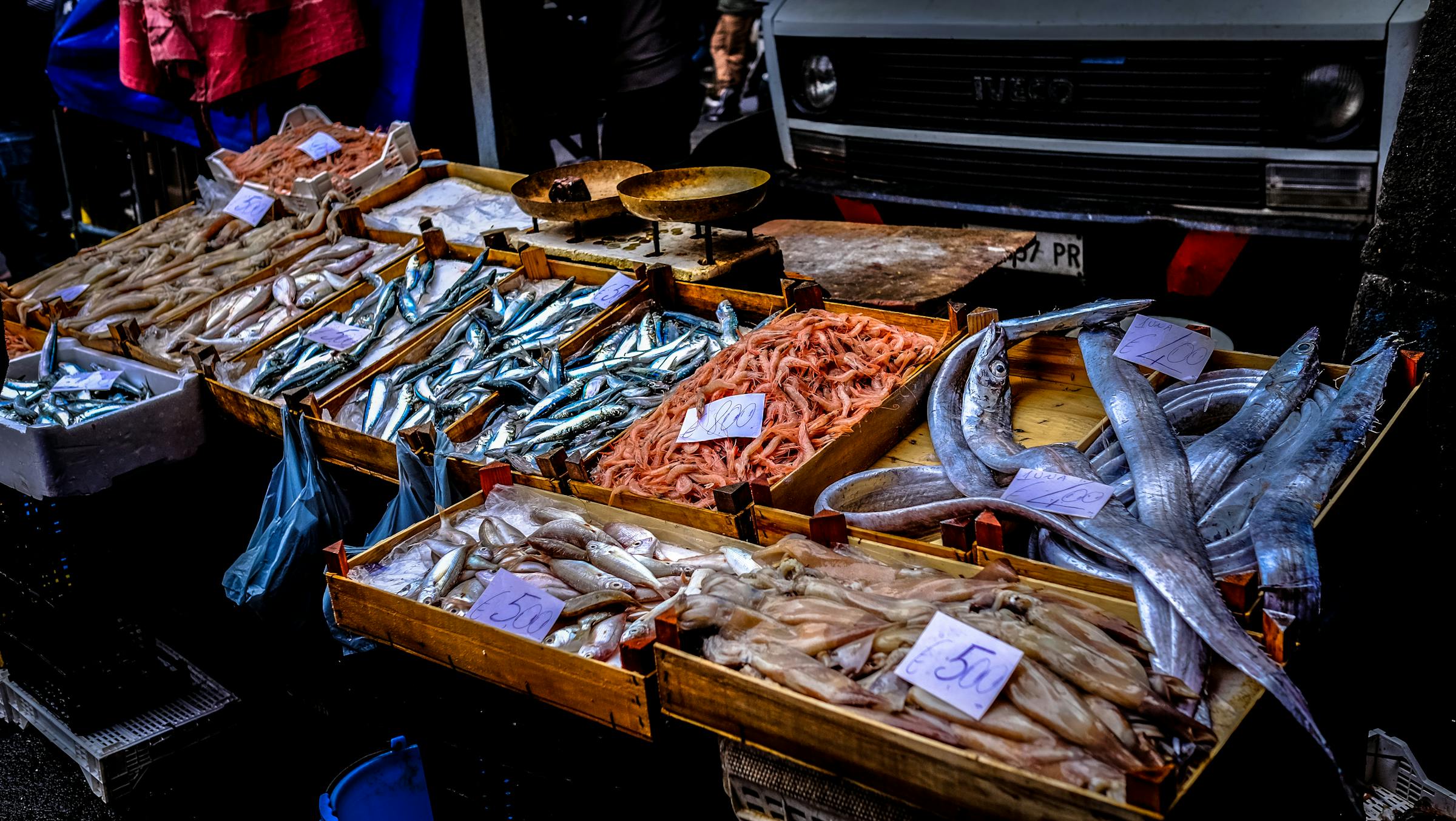 Fresh seafood and produce on display at a coastal outdoor market